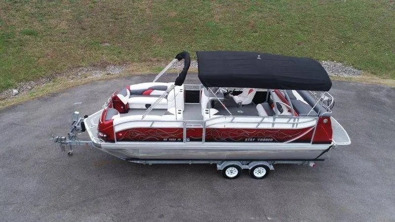Slide: The Image of 2008 JC 246 IO pontoon boat with black canopy on trailer. - 1