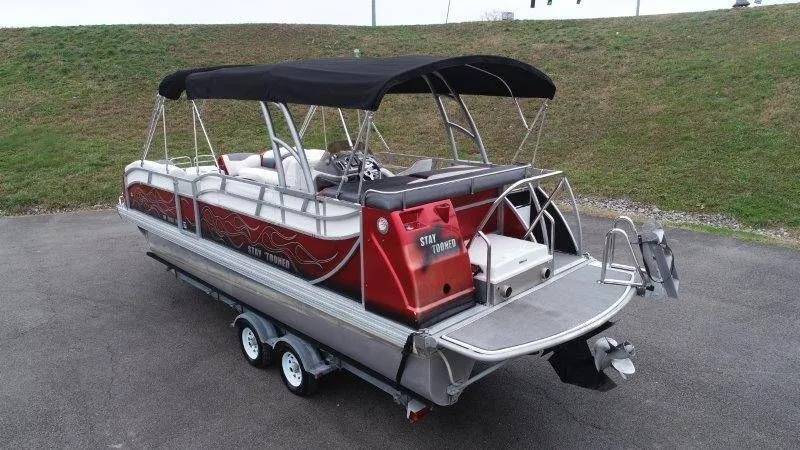 Slide: The Image of 2008 JC 246 IO pontoon boat with black canopy and red accents. - 10