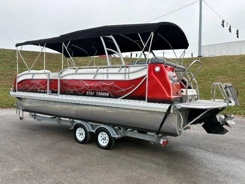 Slide: The Image of 2008 JC 246 IO pontoon boat with red design and black canopy. - 11