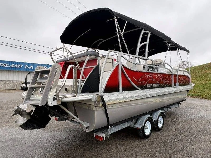 Slide: The Image of 2008 JC 246 IO pontoon boat with black canopy on trailer. - 18