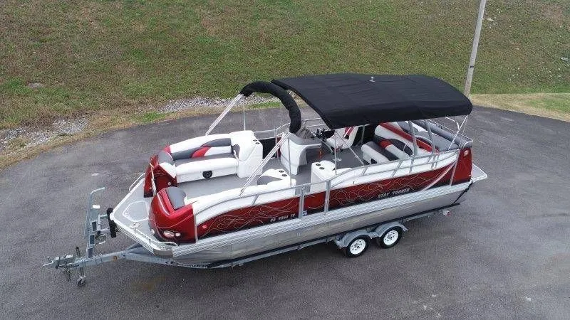 Slide: The Image of 2008 JC 246 IO pontoon boat with black canopy on trailer. - 2
