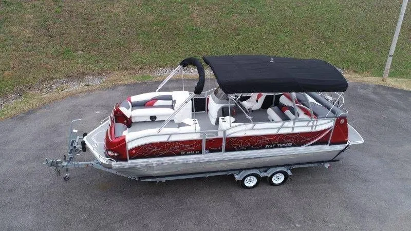 Slide: The Image of 2008 JC 246 IO pontoon boat with black canopy on trailer. - 3