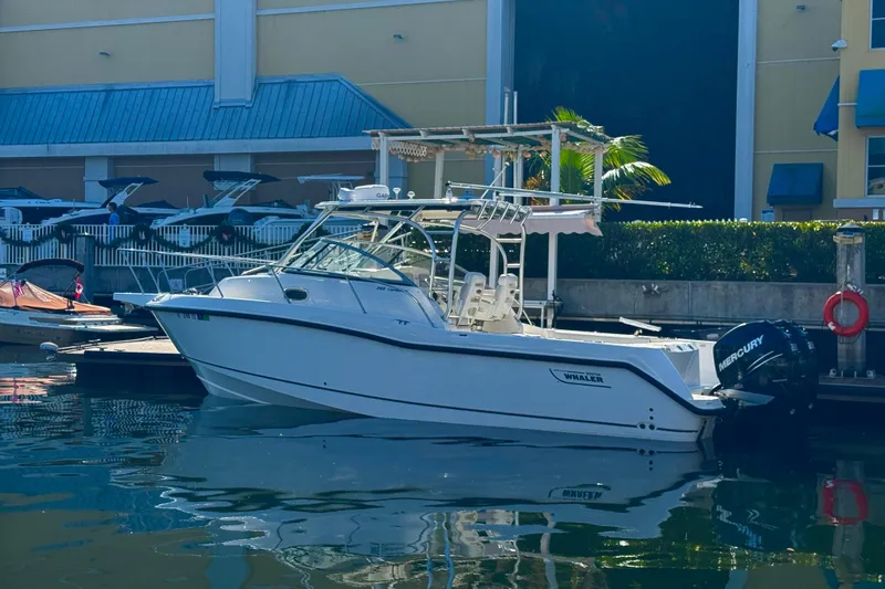 The Image of 2006 Boston Whaler 285 Conquest boat docked at marina with Mercury engines. - 0