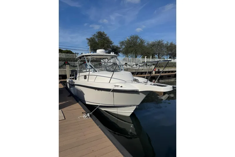 Slide: The Image of 2006 Boston Whaler 285 Conquest boat docked on a sunny day. - 1