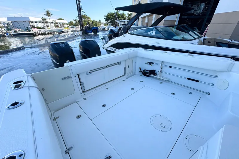 Slide: The Image of 2006 Boston Whaler 285 Conquest boat deck with dual Mercury engines, docked at marina. - 10