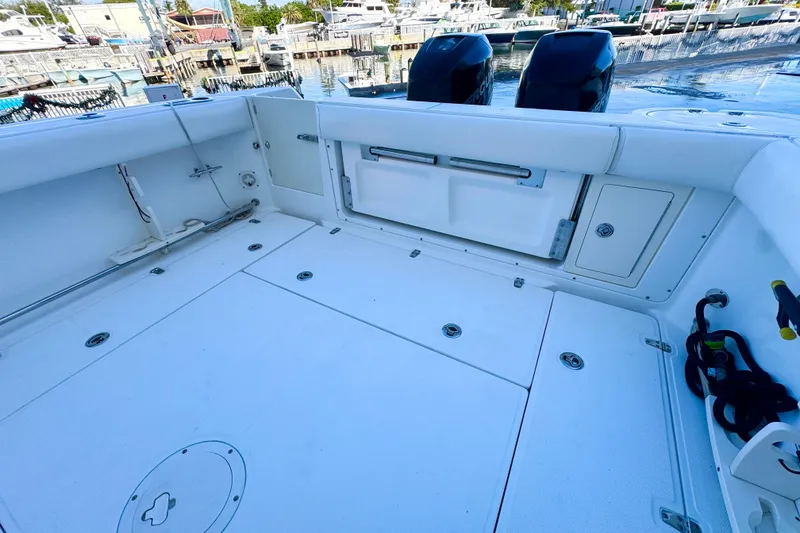 Slide: The Image of 2006 Boston Whaler 285 Conquest boat deck with storage compartments and twin engines. - 12