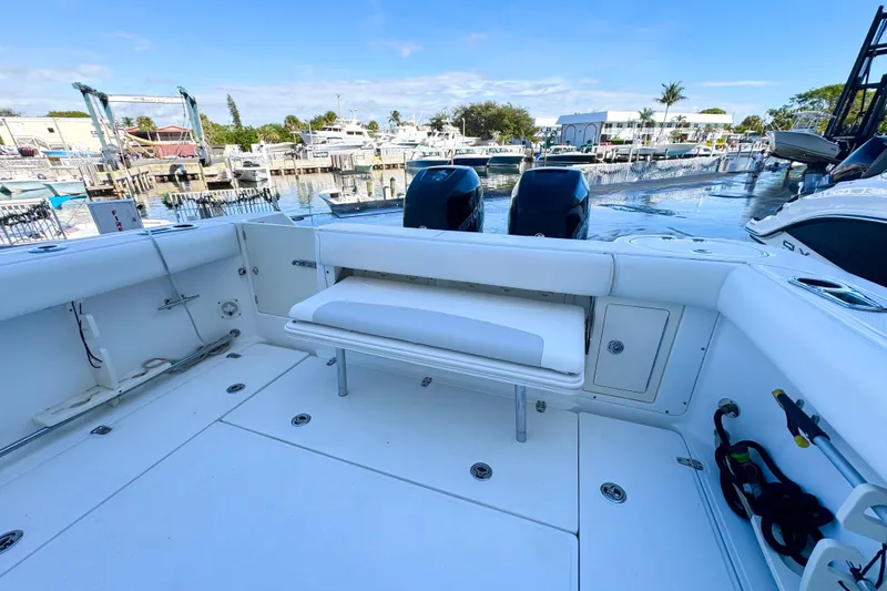 Slide: The Image of 2006 Boston Whaler 285 Conquest boat interior with seating and dual engines at marina. - 13