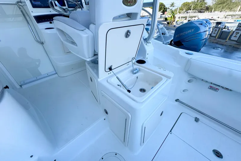 Slide: The Image of 2006 Boston Whaler 285 Conquest boat interior with sink and seating area. - 15