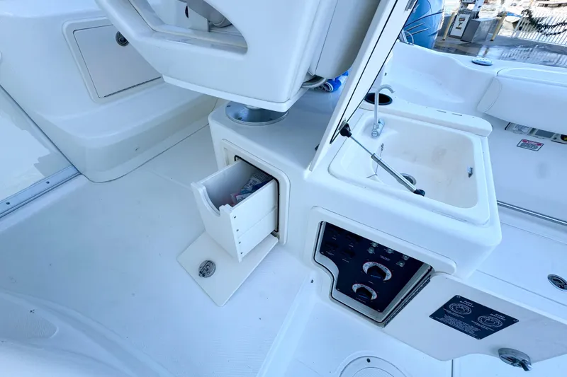 Slide: The Image of 2006 Boston Whaler 285 Conquest interior with storage and control panel. - 16