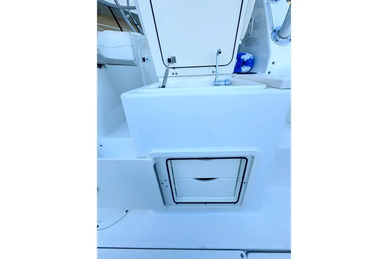 Slide: The Image of 2006 Boston Whaler 285 Conquest interior storage and sink area. - 17