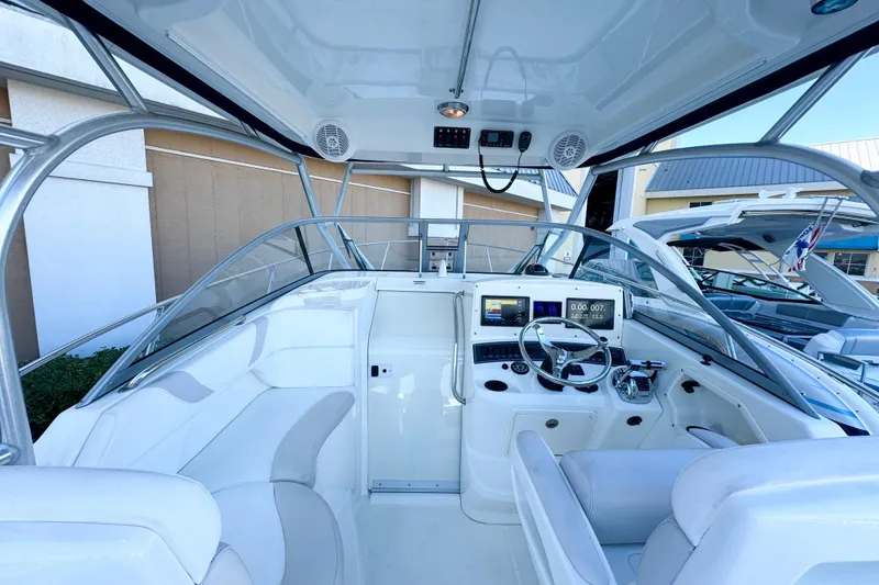Slide: The Image of 2006 Boston Whaler 285 Conquest boat interior with modern dashboard and seating. - 18