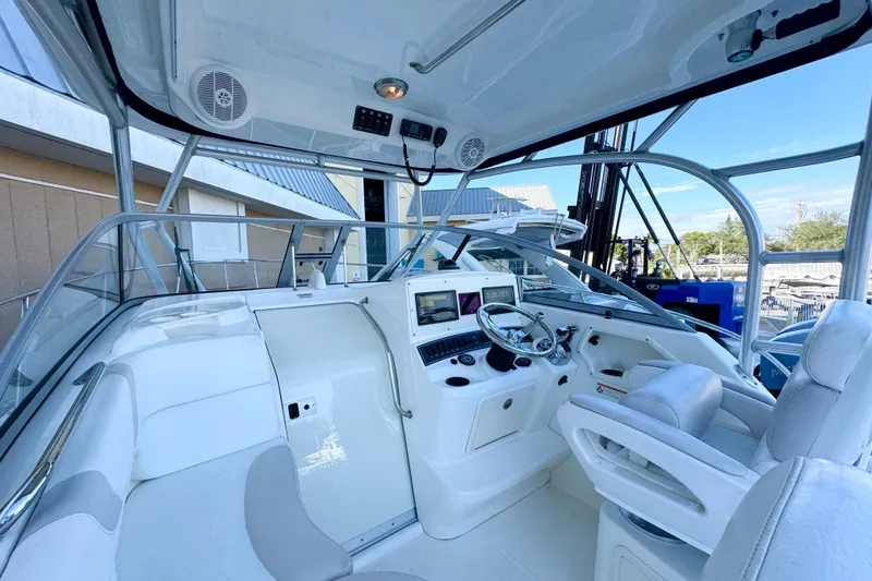 Slide: The Image of 2006 Boston Whaler 285 Conquest boat interior with helm, seating, and navigation equipment. - 19