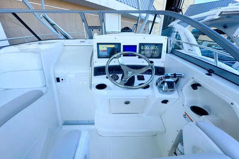 Slide: The Image of 2006 Boston Whaler 285 Conquest helm with modern navigation displays and controls. - 20