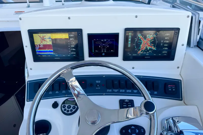 Slide: The Image of Dashboard of a 2006 Boston Whaler 285 Conquest with navigation screens and controls. - 21