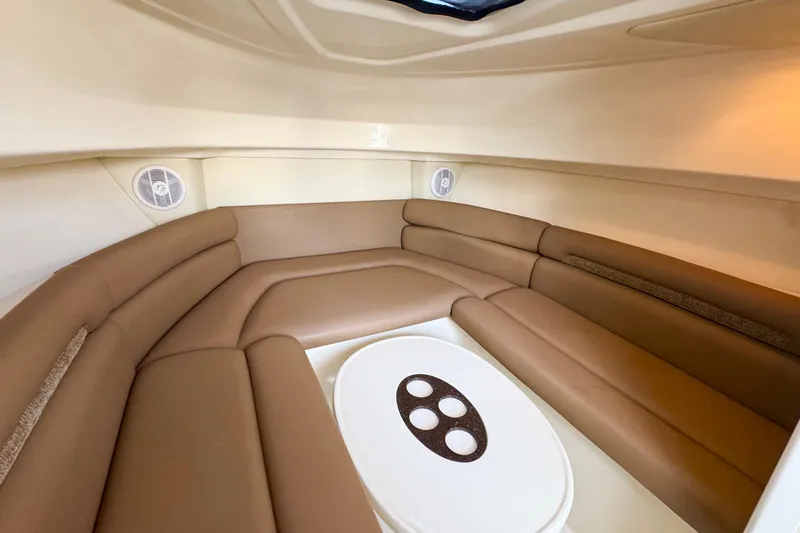 Slide: The Image of Interior of 2006 Boston Whaler 285 Conquest, featuring cozy seating and a central table. - 25