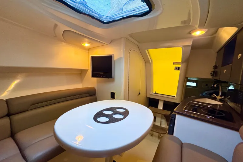 Slide: The Image of Interior of 2006 Boston Whaler 285 Conquest with seating, table, and kitchenette. - 28