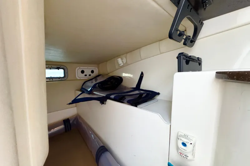 Slide: The Image of 2006 Boston Whaler 285 Conquest cabin interior with storage and equipment. - 31