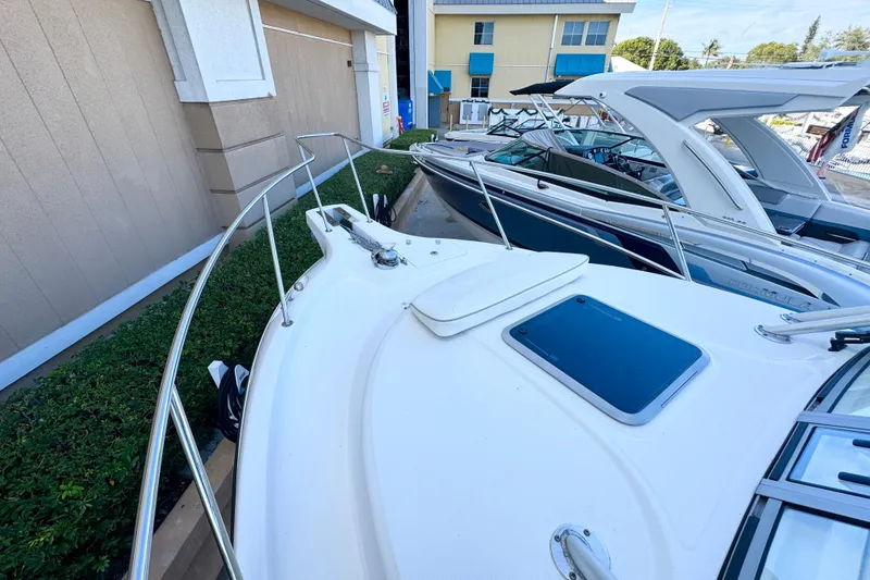 Slide: The Image of 2006 Boston Whaler 285 Conquest boat docked, showcasing sleek design and spacious deck. - 34