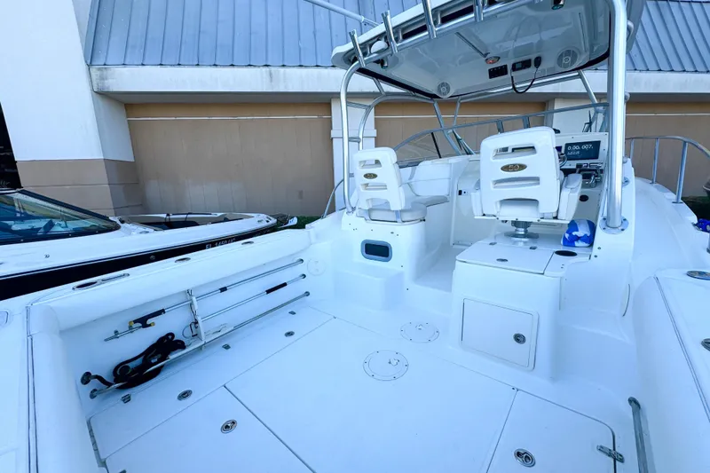 Slide: The Image of 2006 Boston Whaler 285 Conquest boat interior with seating and fishing equipment. - 5