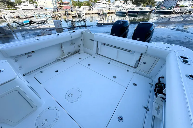 Slide: The Image of 2006 Boston Whaler 285 Conquest boat deck with twin engines at marina. - 7