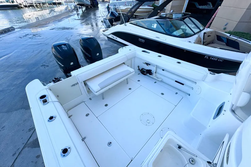 Slide: The Image of 2006 Boston Whaler 285 Conquest boat with spacious deck and dual Mercury engines. - 9