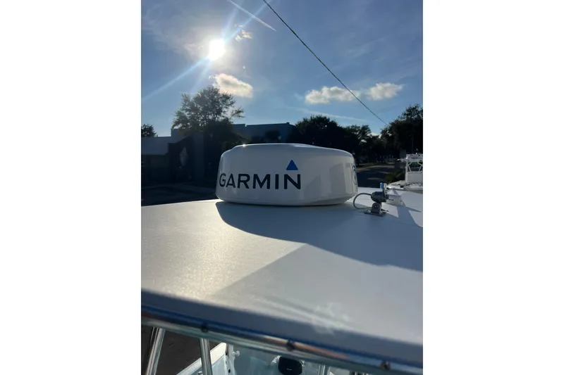 Slide: The Image of 2024 Contender 24 Sport boat with Garmin radar under a sunny sky. - 11