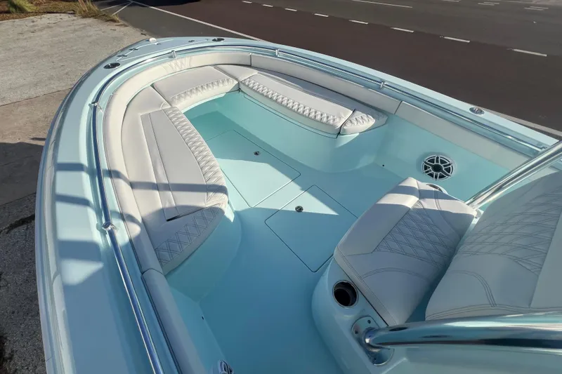 Slide: The Image of 2024 Contender 24 Sport boat interior with white cushioned seating and sleek design. - 3