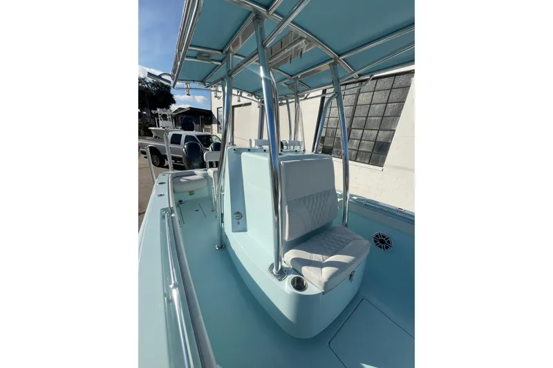 Slide: The Image of 2024 Contender 24 Sport boat interior with seating and T-top, showcasing sleek design. - 4