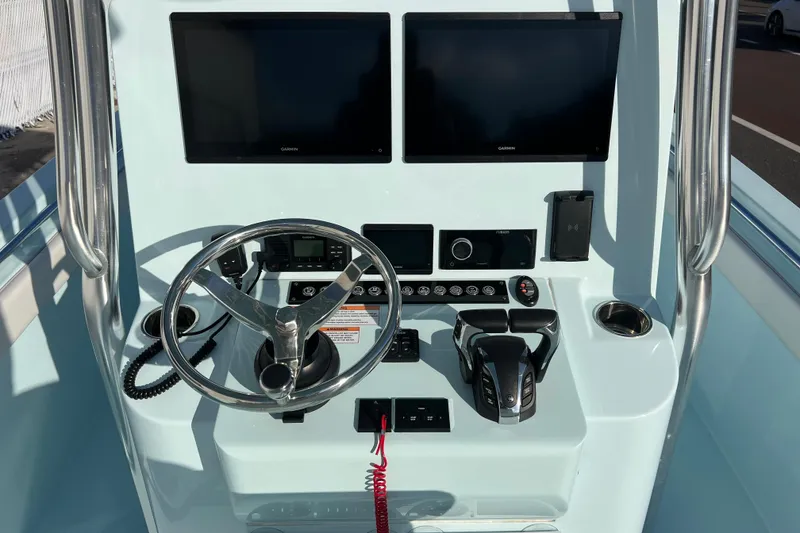 Slide: The Image of 2024 Contender 24 Sport boat dashboard with dual Garmin screens and modern controls. - 7