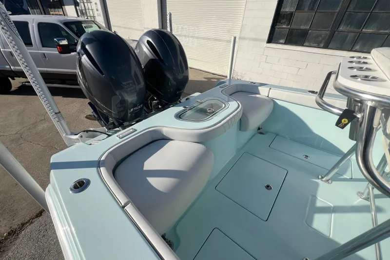 Slide: The Image of 2024 Contender 24 Sport boat with dual engines and spacious seating area. - 9