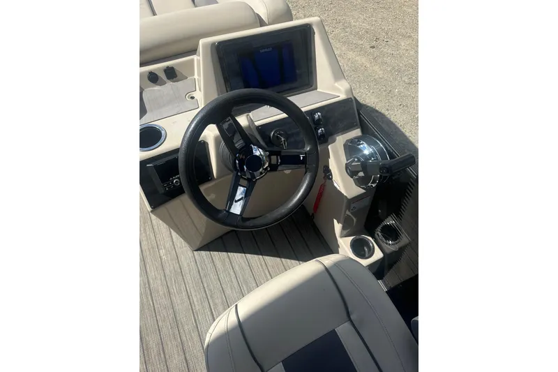Slide: The Image of 2023 Harris HCX 230 Swingback boat dashboard with steering wheel and controls. - 10