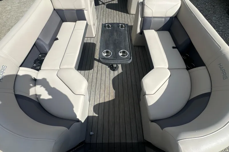 Slide: The Image of 2023 Harris HCX 230 Swingback boat interior with plush seating and central table. - 14