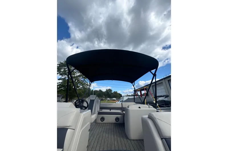 Slide: The Image of 2023 Harris HCX 230 Swingback pontoon boat with canopy under cloudy sky. - 19