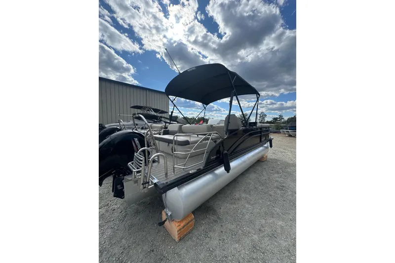 Slide: The Image of 2023 Harris HCX 230 Swingback pontoon boat with canopy under a cloudy sky. - 24