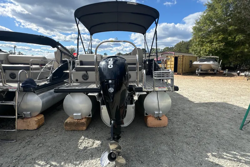 Slide: The Image of 2023 Harris HCX 230 Swingback pontoon boat with 150 HP engine, parked outdoors. - 25