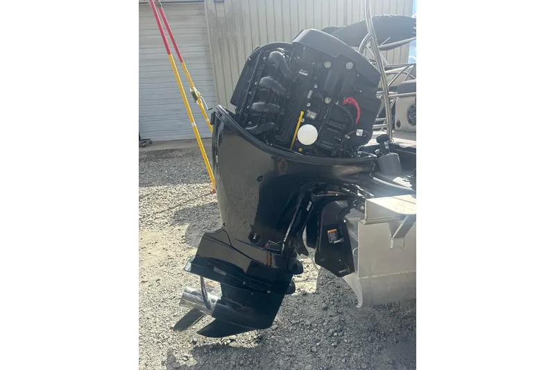 Slide: The Image of 2023 Harris HCX 230 Swingback boat motor, outdoor setting, close-up view. - 28