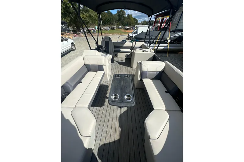 Slide: The Image of 2023 Harris HCX 230 Swingback boat interior with spacious seating and table. - 3