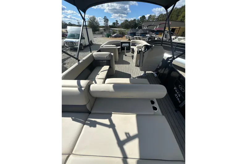 Slide: The Image of 2023 Harris HCX 230 Swingback pontoon boat interior with spacious seating and modern design. - 9
