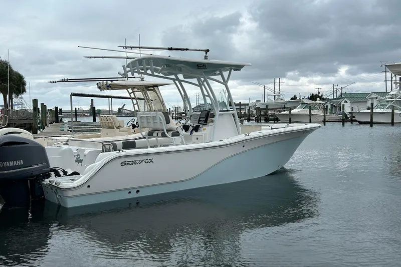 The Image of 2016 Sea Fox 246 Commander boat docked in a marina under cloudy skies. - 0