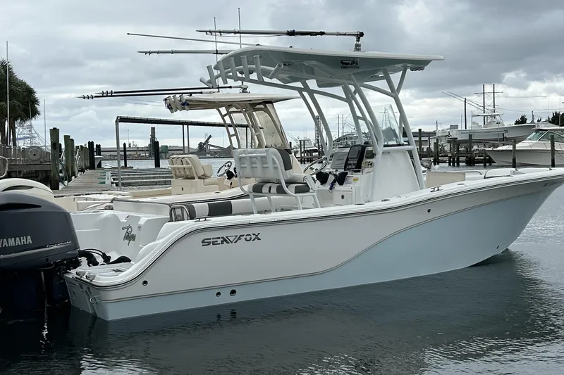 Slide: The Image of 2016 Sea Fox 246 Commander boat docked, featuring Yamaha outboard motor. - 1