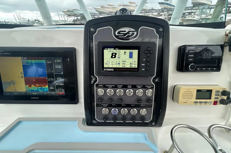 Slide: The Image of Control panel of a 2016 Sea Fox 246 Commander boat with Garmin and Yamaha displays. - 10