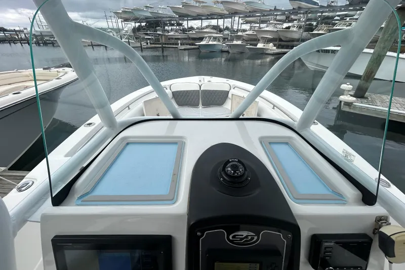 Slide: The Image of 2016 Sea Fox 246 Commander boat dashboard with marina view. - 16