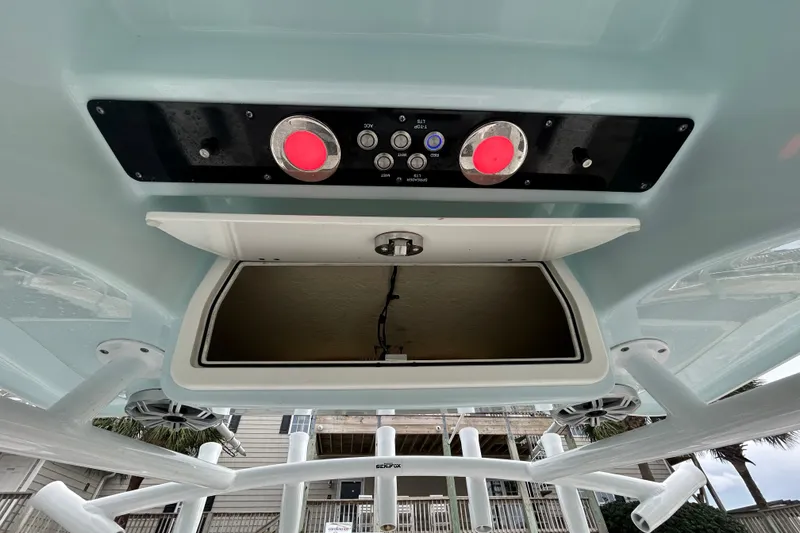 Slide: The Image of 2016 Sea Fox 246 Commander boat console with open storage compartment and control panel. - 19