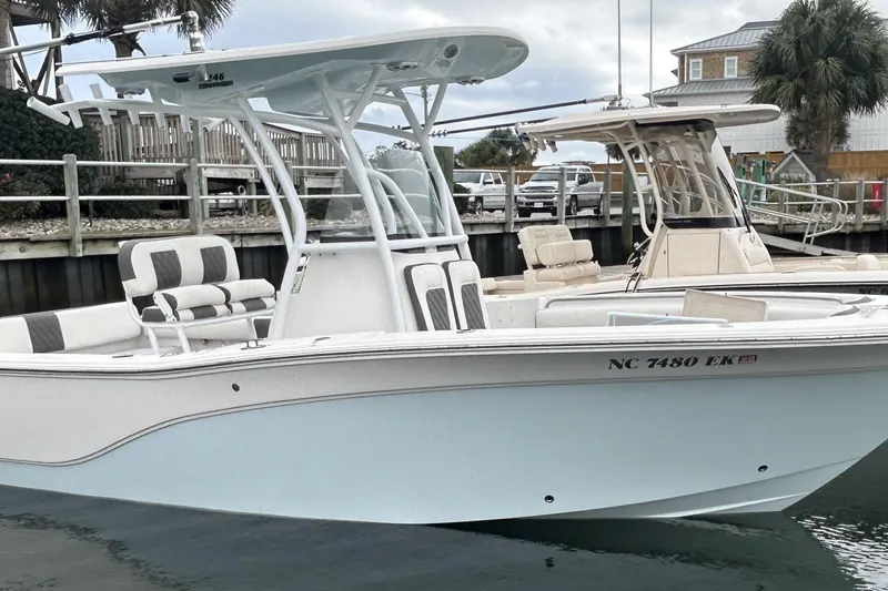 Slide: The Image of 2016 Sea Fox 246 Commander boat docked, featuring sleek design and comfortable seating. - 2