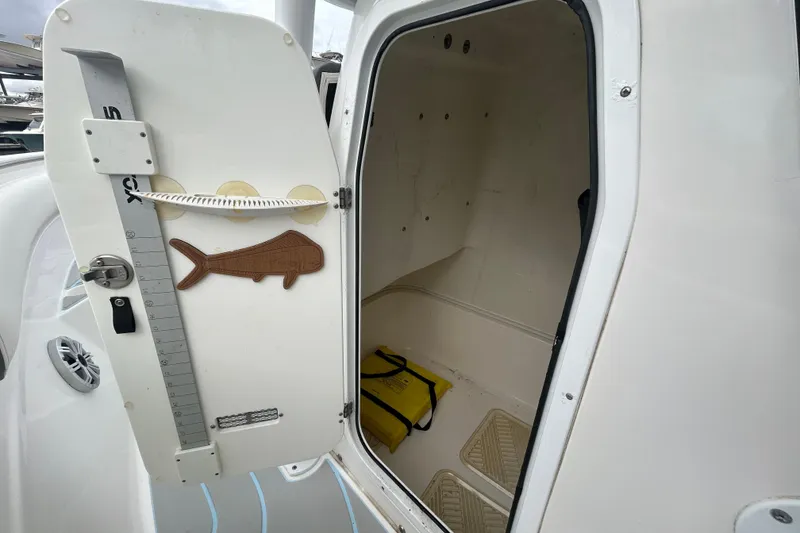 Slide: The Image of 2016 Sea Fox 246 Commander boat interior with open storage compartment and fish ruler. - 20