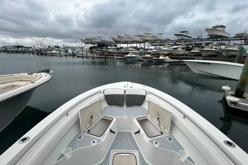 Slide: The Image of 2016 Sea Fox 246 Commander boat docked at marina with overcast sky. - 22
