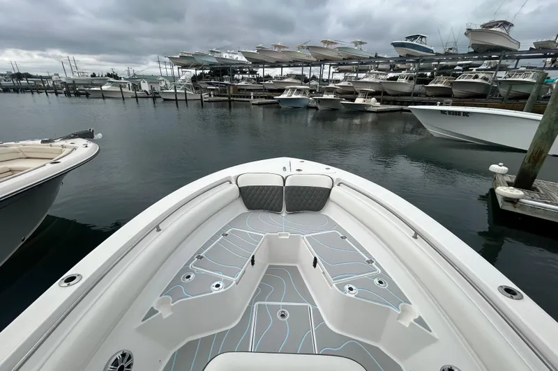 Slide: The Image of 2016 Sea Fox 246 Commander boat docked at a marina under cloudy skies. - 23