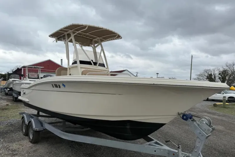 Slide: The Image of 2023 Scout 215 XSF boat on trailer under cloudy sky. - 3