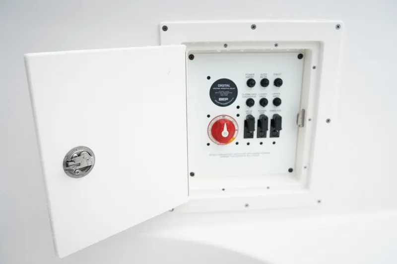 Slide: The Image of Electrical control panel on 2026 Chaparral 270 OSX boat with open access door. - 10