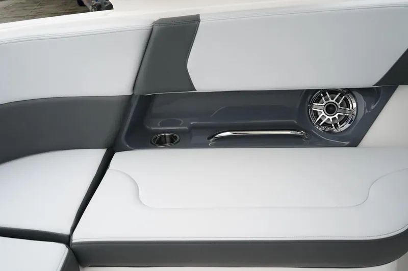 Slide: The Image of 2026 Chaparral 270 OSX boat interior with gray and white seating, speaker, and cup holder. - 12